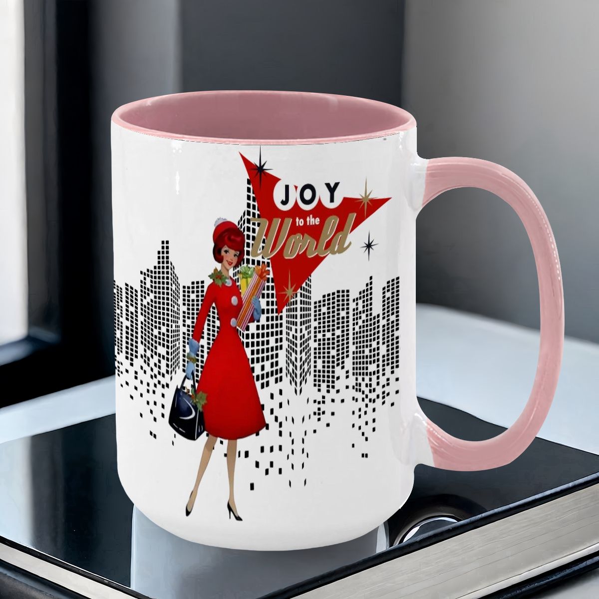 Mid Century Modern holiday mug featuring a cityscape design and a woman in red with the text "Joy to the World.