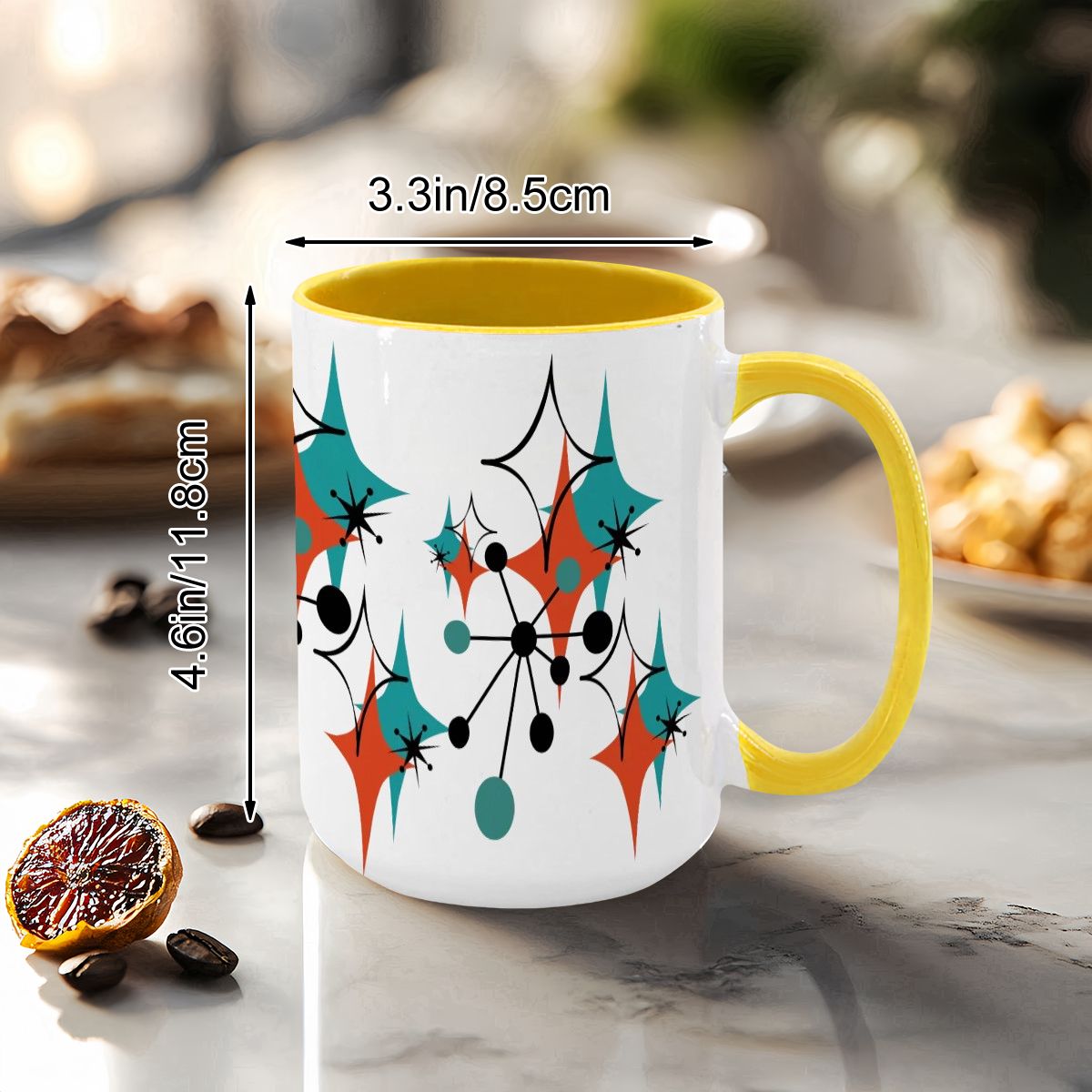 Colorful 15oz mug featuring a Mid Century Modern atomic starburst design in teal, orange, and black with a yellow handle.