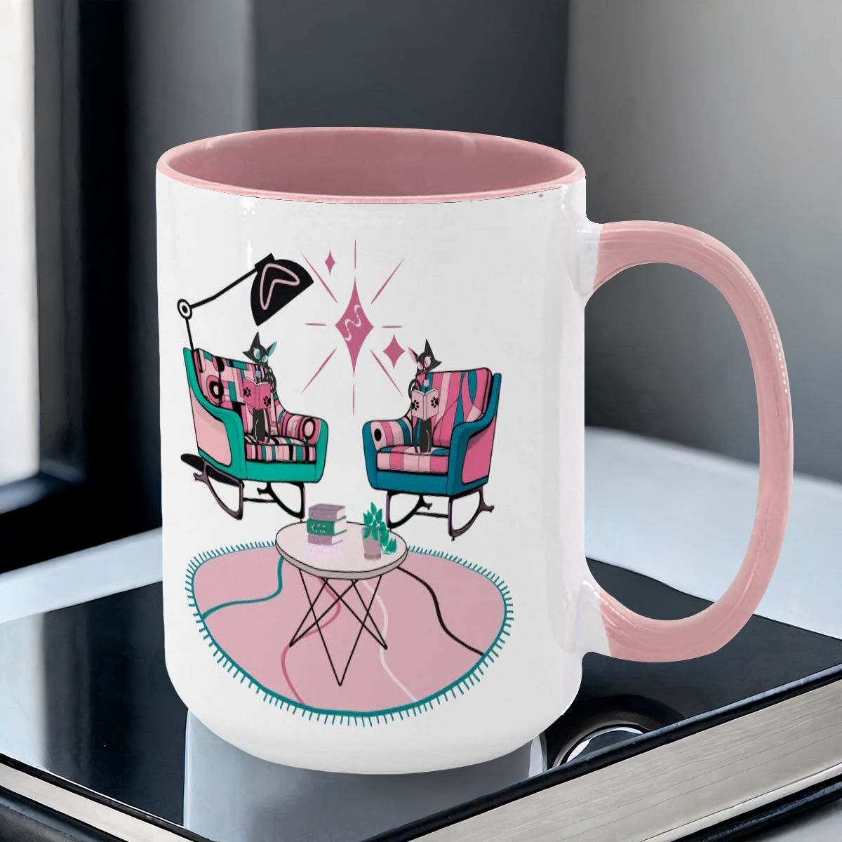 Colorful 15oz mug featuring atomic reading cats in mid-century modern chairs with a retro table and decor.