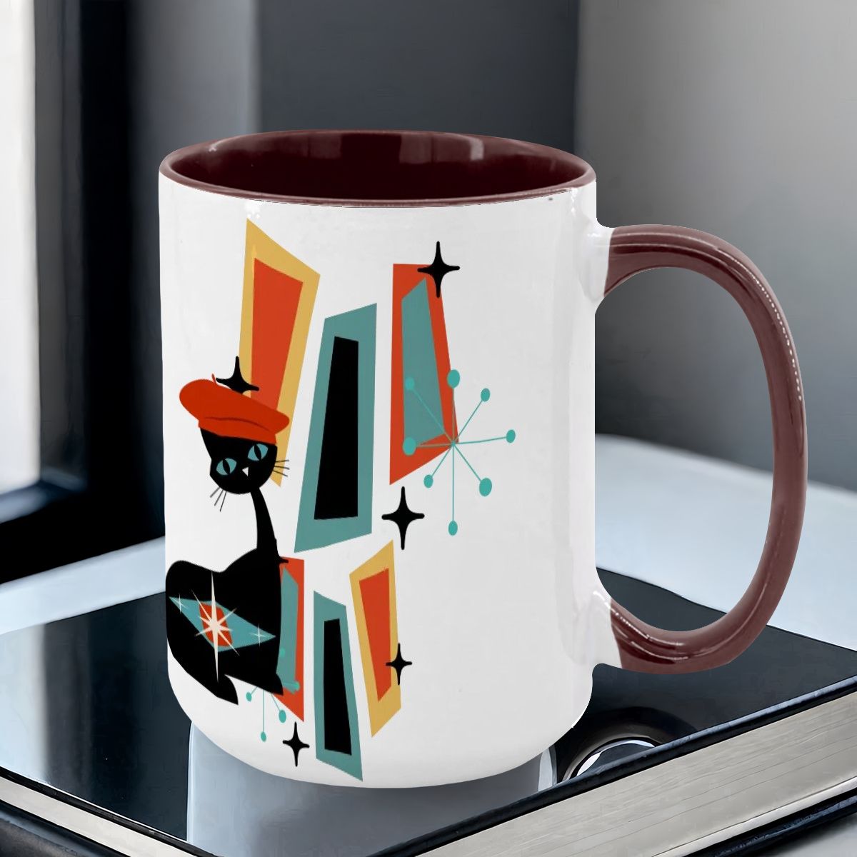 Mid Century Modern coffee mug featuring an atomic cat design with geometric shapes in vibrant colors.