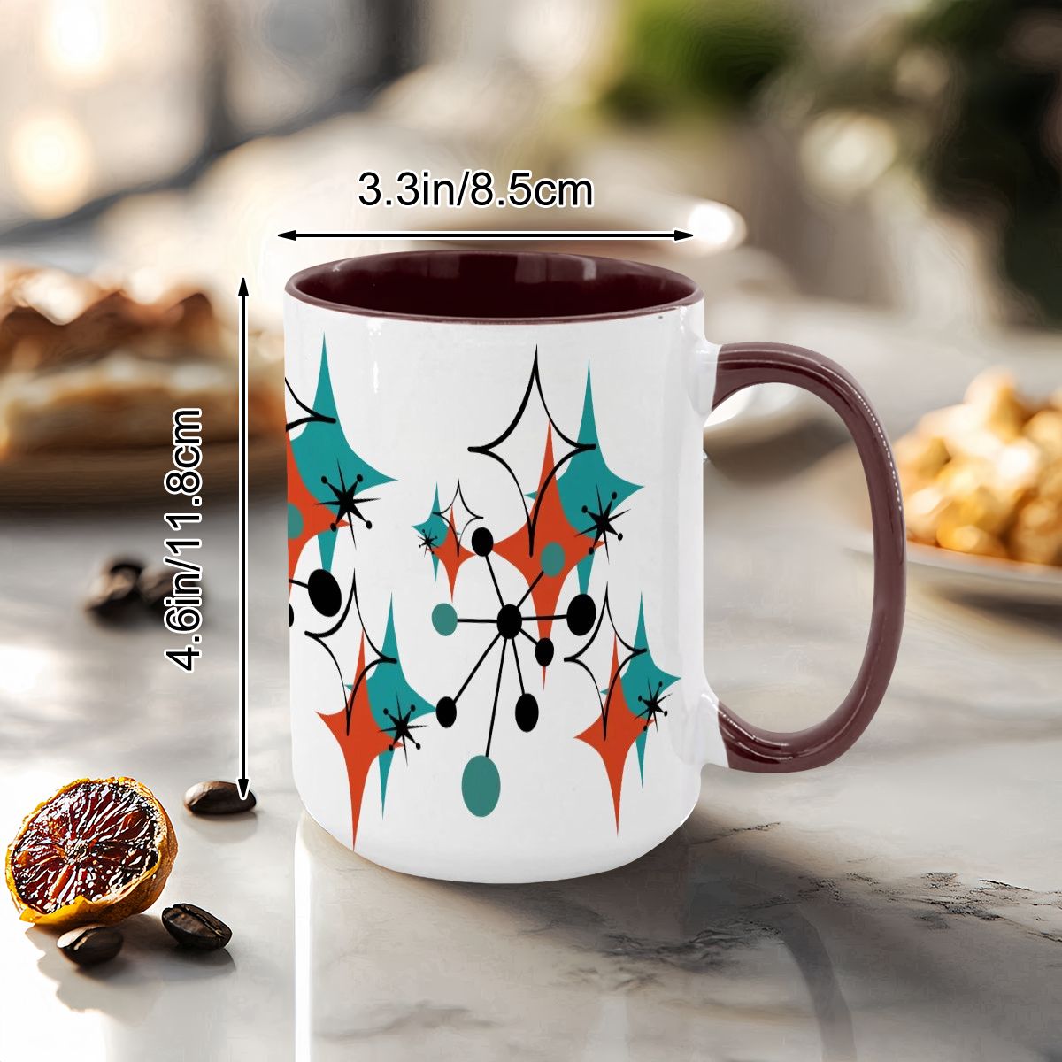 Colorful 15oz mug featuring a Mid Century Modern atomic starburst design in teal, orange, and black on a white background.