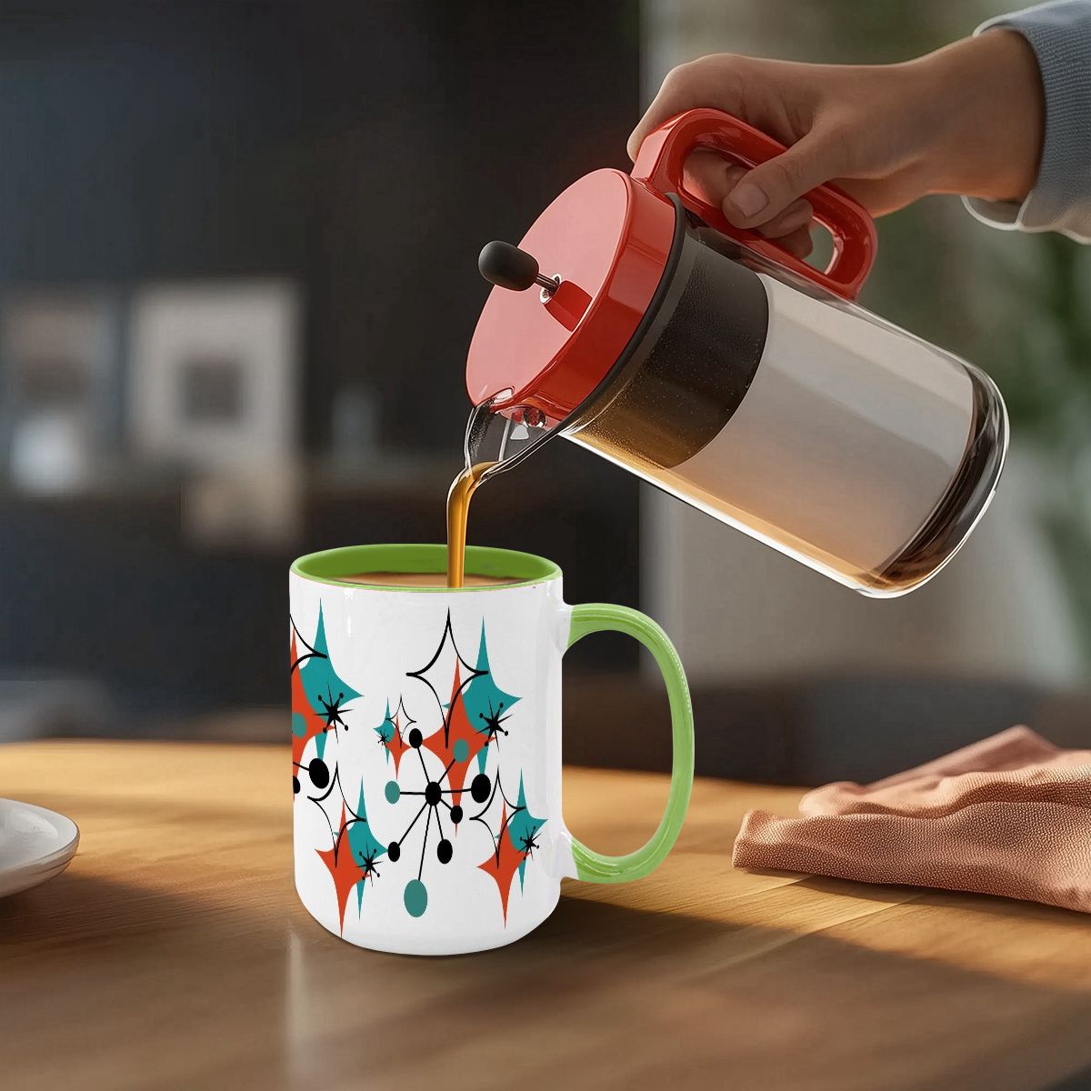 Large 15oz mug featuring a colorful atomic starburst design in teal, orange, and black, with a green handle.