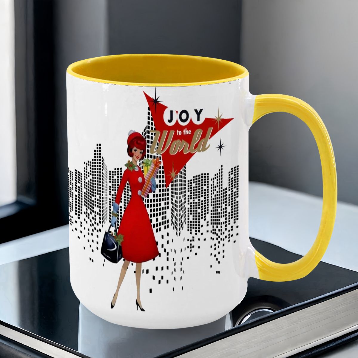 Mid Century Modern holiday mug featuring a cityscape design and a woman in a red dress with "Joy to the World" text.