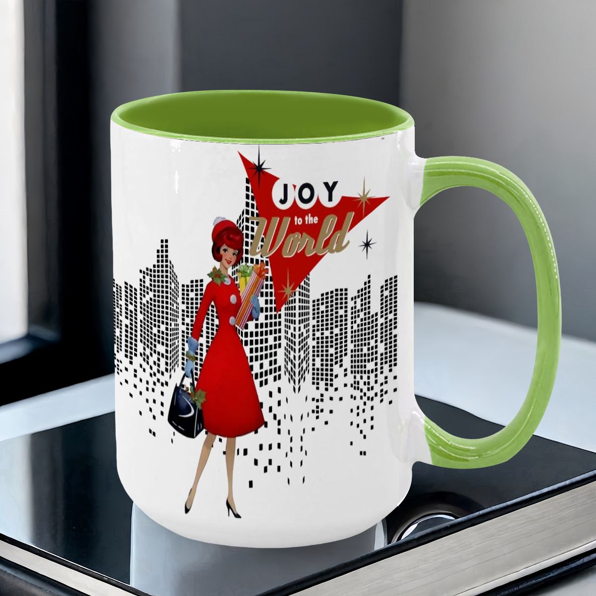 Mid Century Modern holiday mug featuring a cityscape, a woman in a red dress, and "Joy to the World" text in vibrant colors.